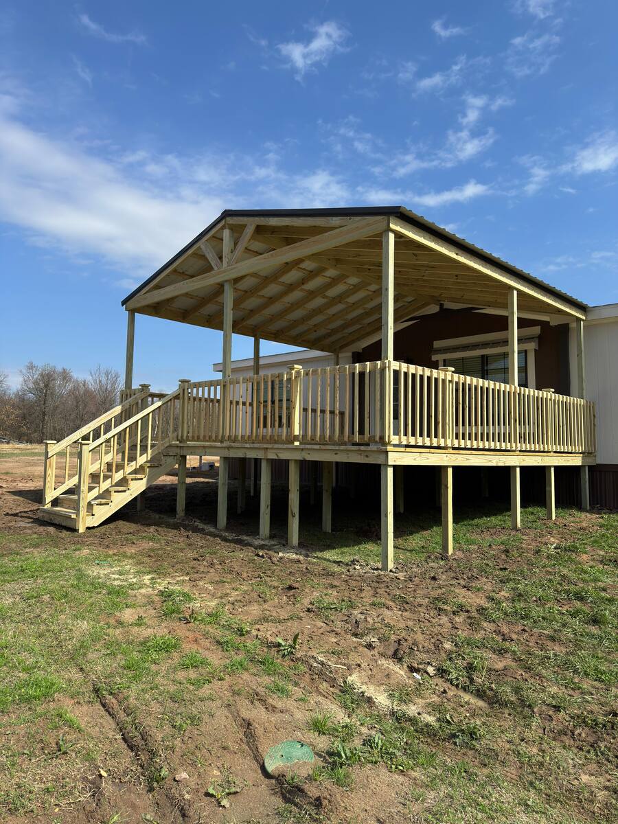 Light wood backyard deck with metal railings