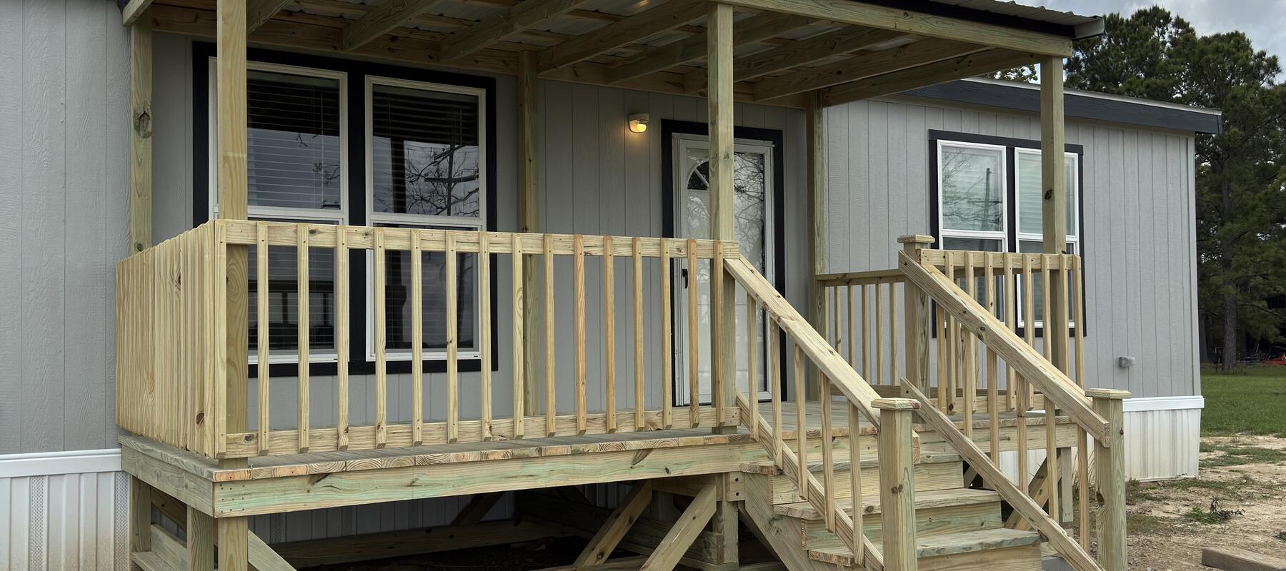 Lavell Decks manufactured home entry deck with covered stairs and landing